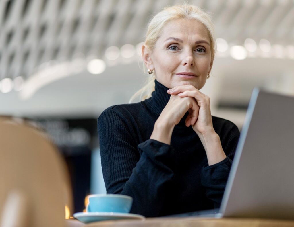 woman having coffee, looking into camera